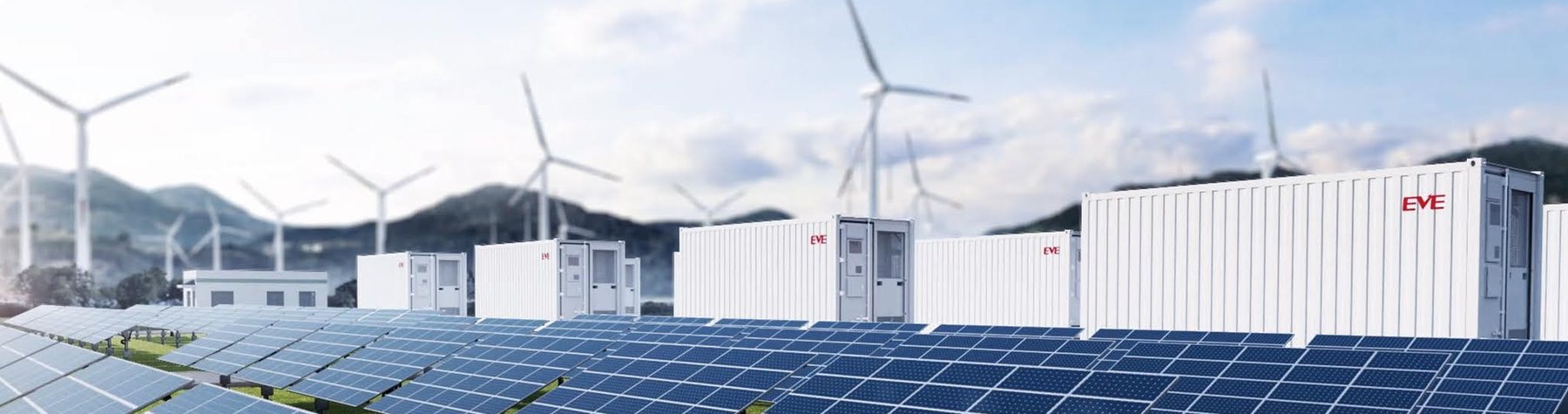 EVE energy storage containers beside a solar farm and wind turbines